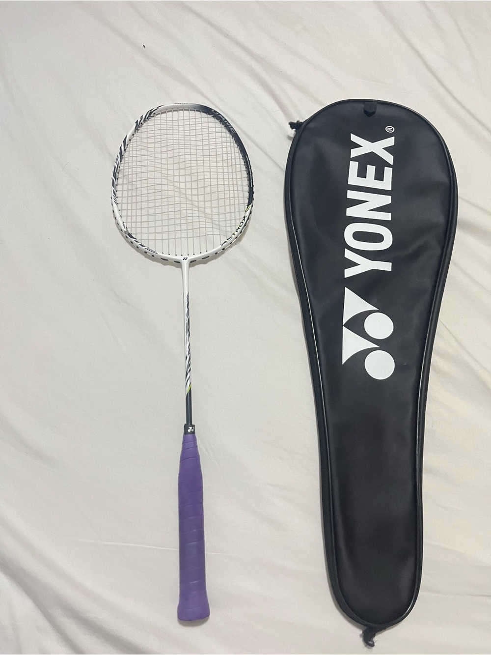 White Yonex Badminton Racket with Purple Grip and Black Carry Case